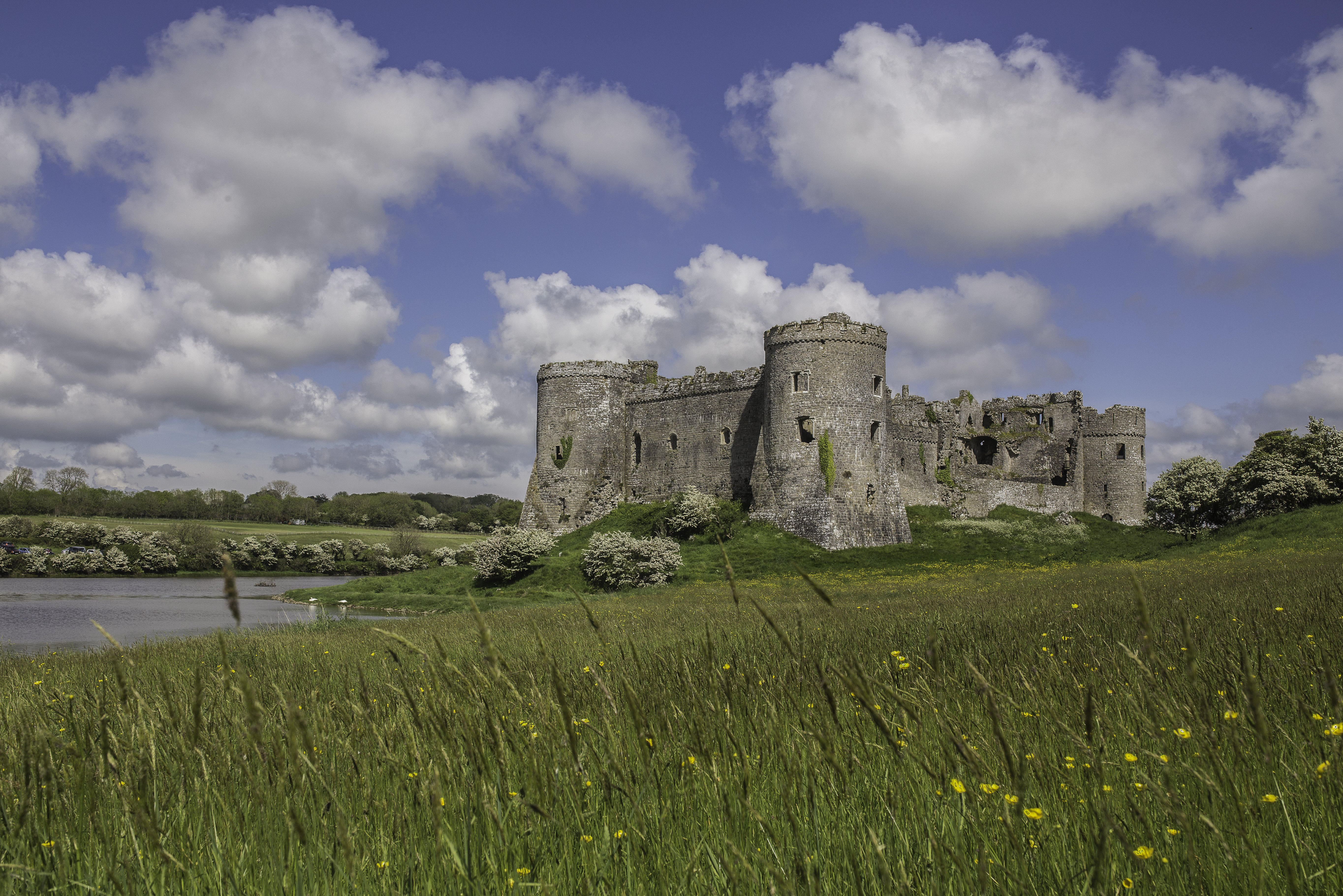 Carew Castle - a stone castle overlooking a Millpond