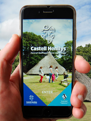 A smartphone with Castell Henllys app on screen