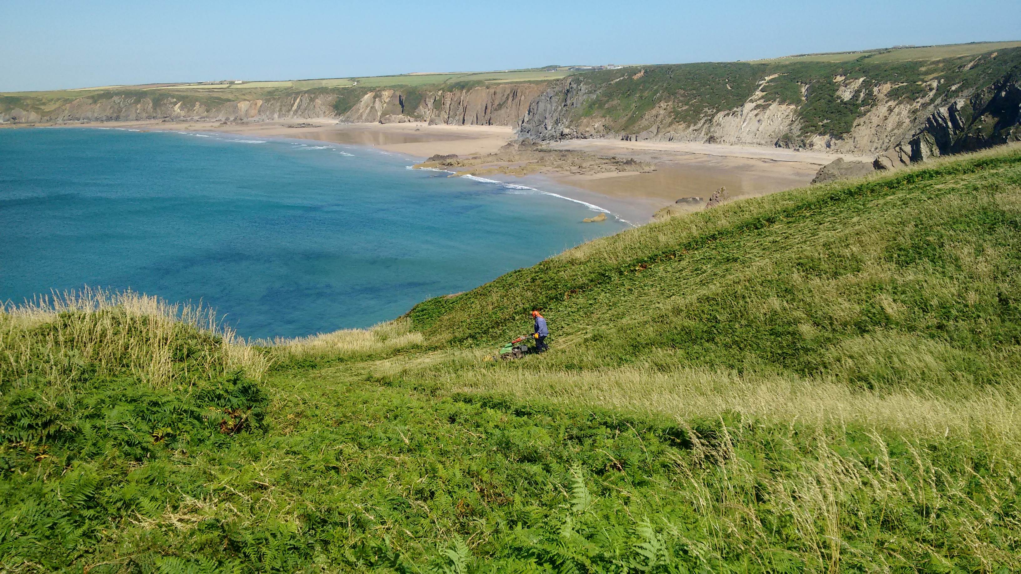 National Park Authority Warden using machine on Coast Path near Marloes Sands