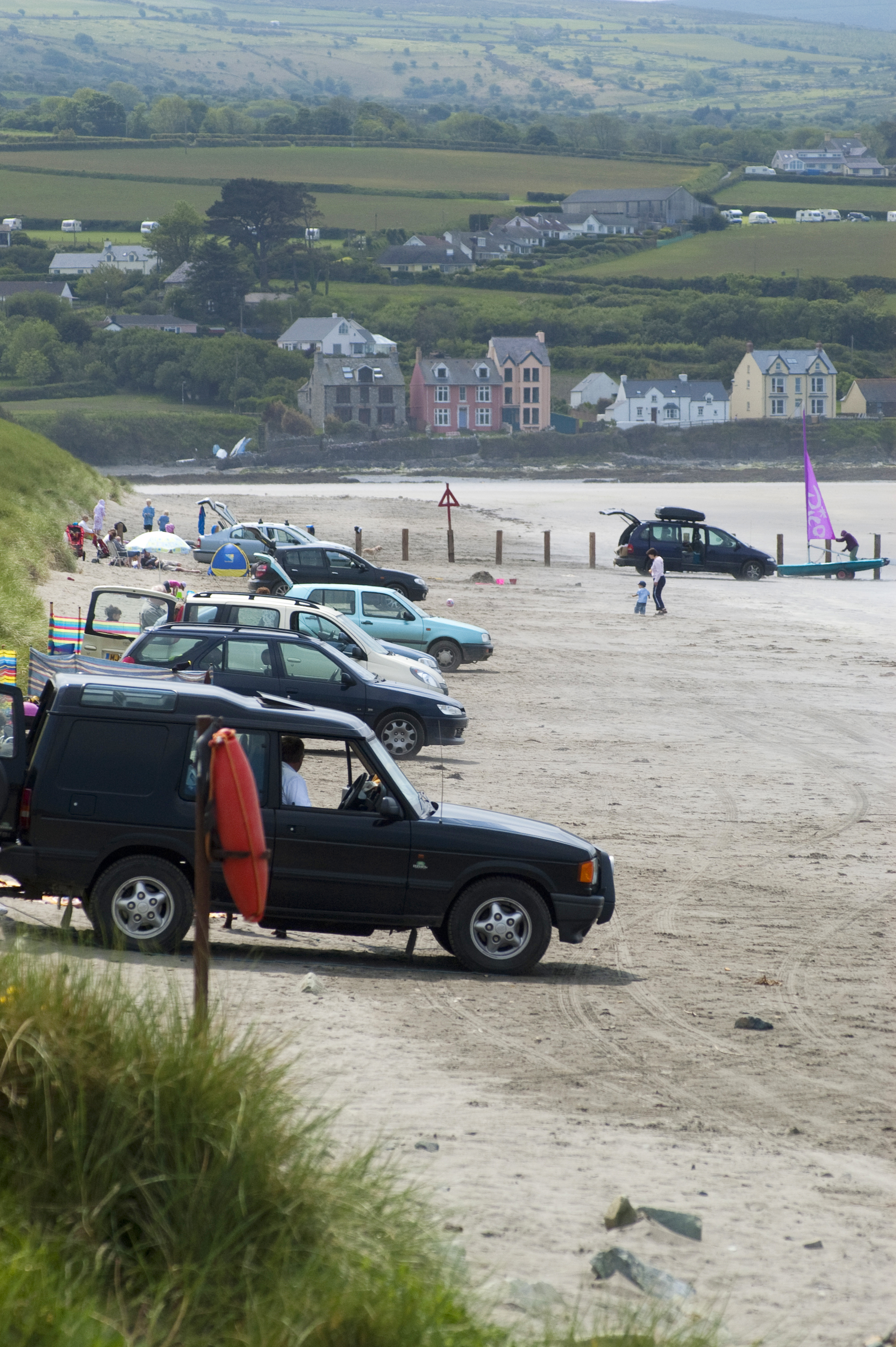 Cars parking on the beach at Newport Sands in the Pembrokeshire Coast National Park