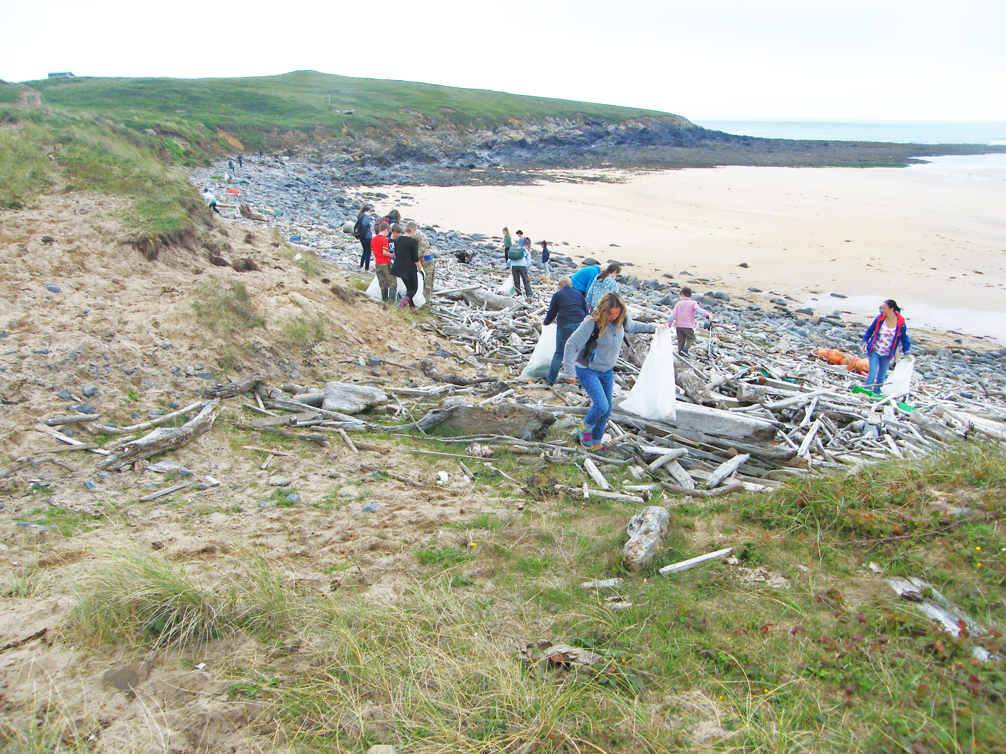 Volunteers on a beach clean at Frainslake on the Castlemartin Range, Pembrokeshire Coast National Park, Wales, UK