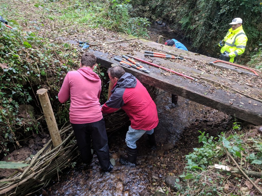 Pathways volunteers working on a bridge at Brandy Brook, Pembrokeshire Coast National Park, Wales, UK