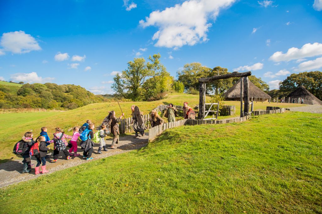 School group enter Castell Henllys Iron Age Village