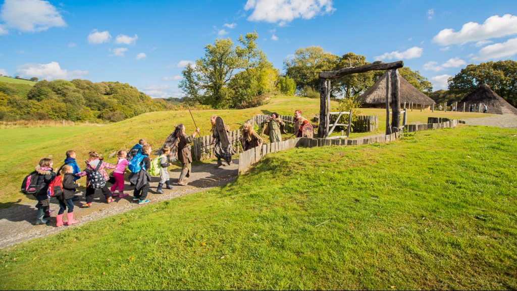 School group enter Castell Henllys Iron Age Village
