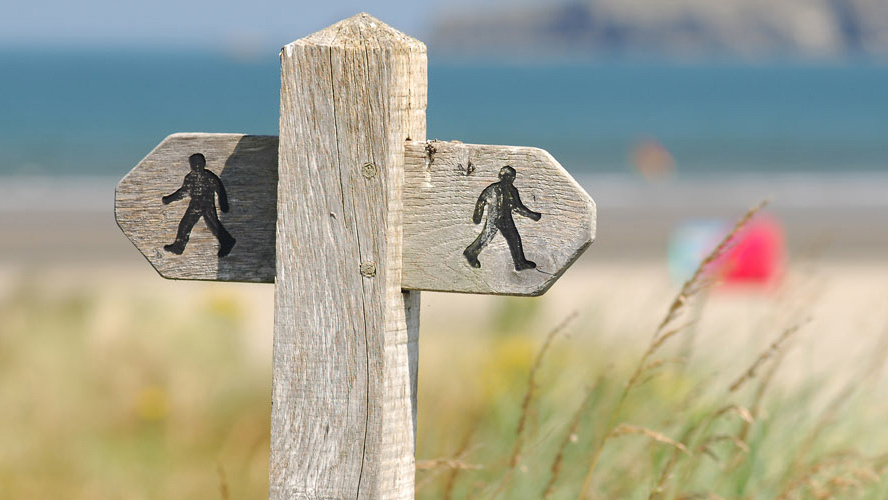 Footpath waymarker at Poppit Sands, Pembrokeshire Coast National Park, Wales, UK