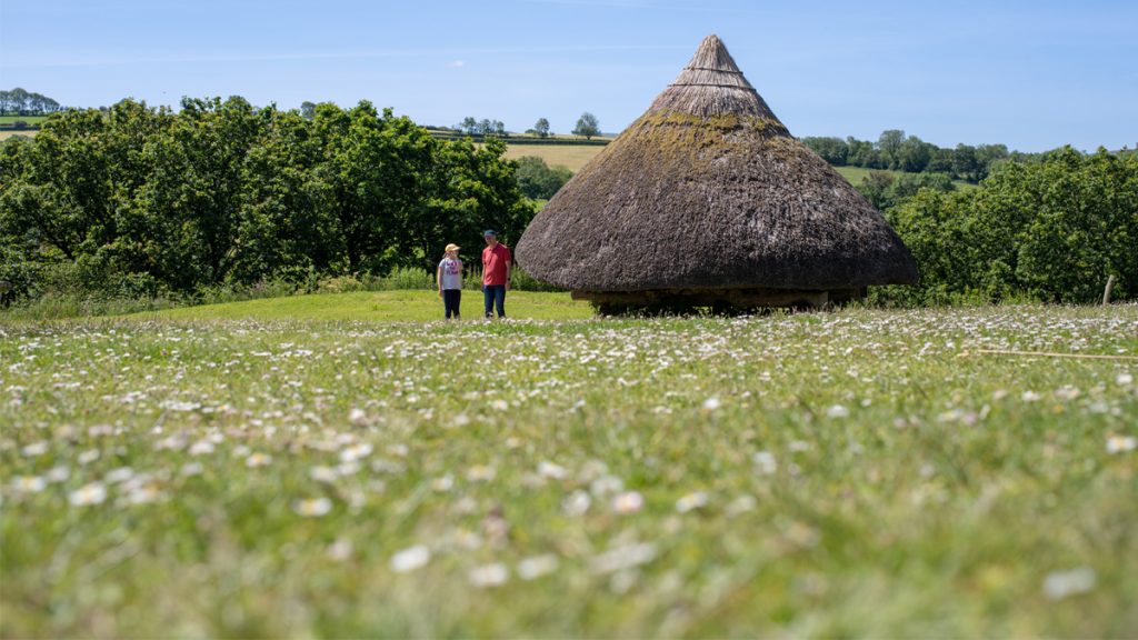 Two people walking at Castell Henllys