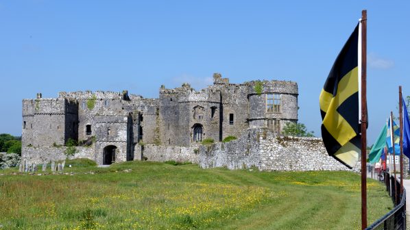Entrance to Carew Castle with flags waving