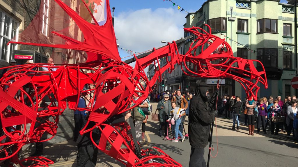 Giant red dragon sculpture during a street parade