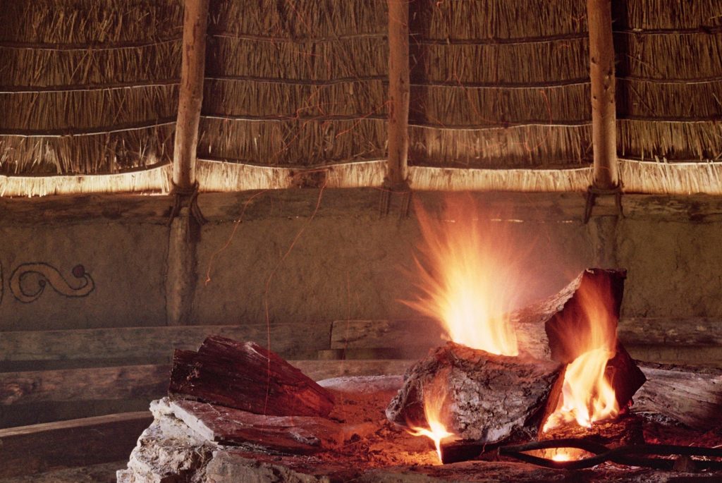 Fire inside Iron Age roundhouse