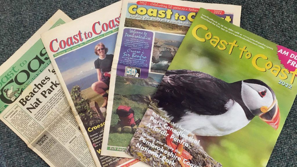 4 magazines laid out on top of each other. Publications pictured are various editions of Coast to Coast