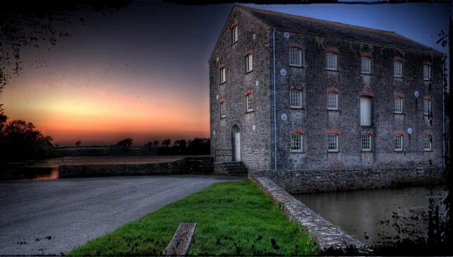 Stone mill building at dusk, location featured is Carew Mill