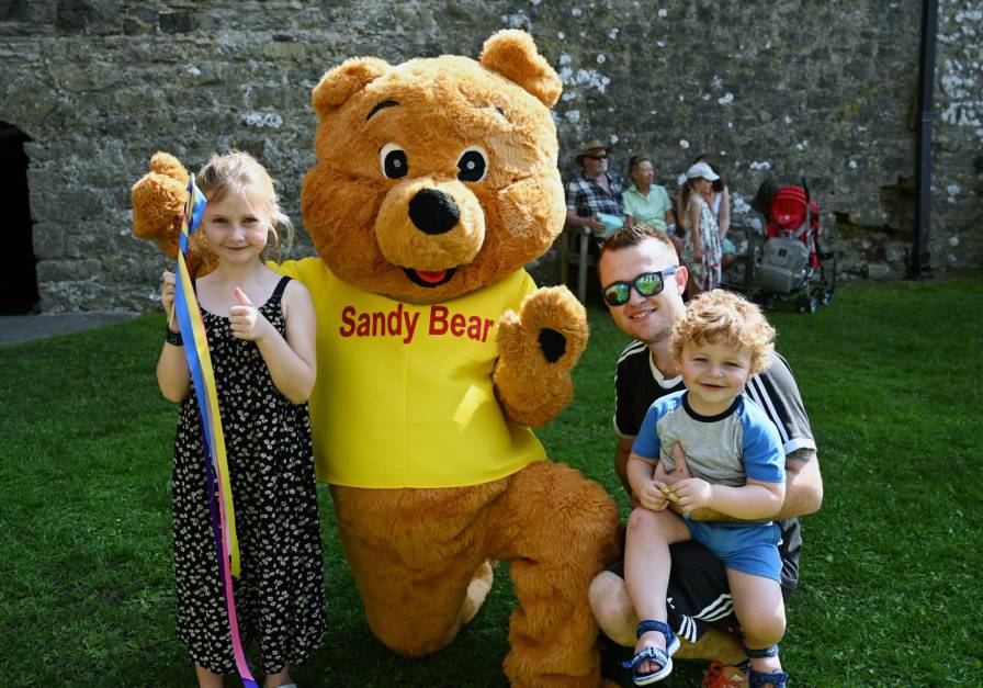A photo of a family with Sandy Bear