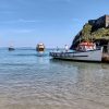 Keith Tenby 2022 Boat moored next to an island in shallow water with two further boats approaching. Location pictured is Tenby, Pembrokeshire