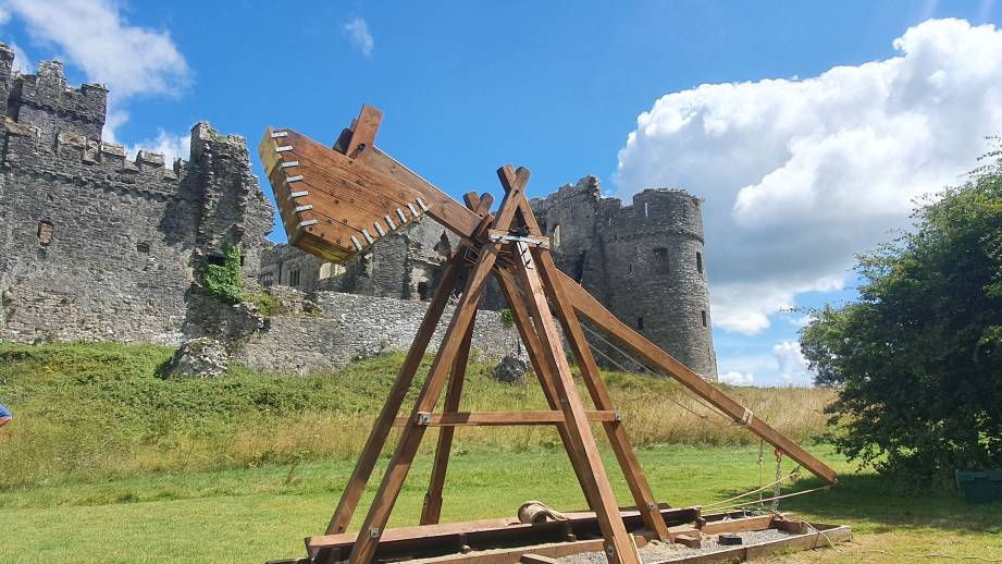 A trebuchet outside the walls of Carew Castle