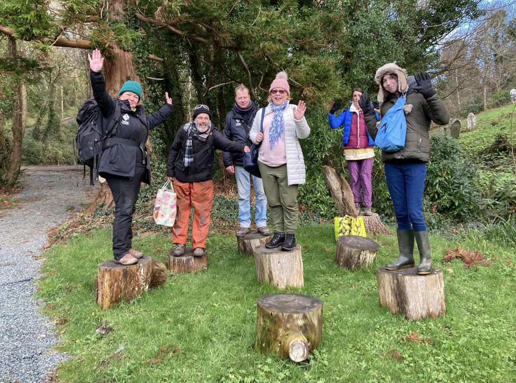 Group of people standing on tree stumps