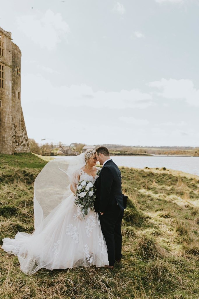 Bride and Groom with Carew Castle and Tidal Mill in background