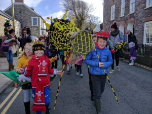 Happy children leading last year's Dragon Parade through the streets of St Davids.