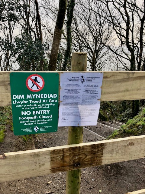 A path closure sign at the entrance to Monkstone Beach