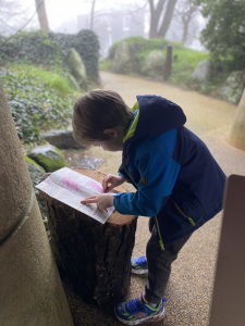 Small male child doing a lino print rubbing