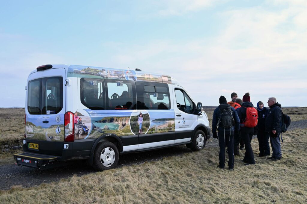 The BMW minibus parked on the Castlemartin Range with volunteers standing nearby