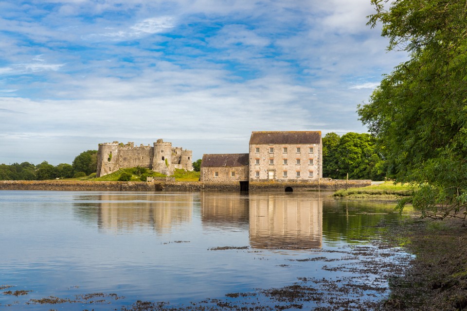 Carew Castle and Tidal Mill on a fine day from across the Millpond