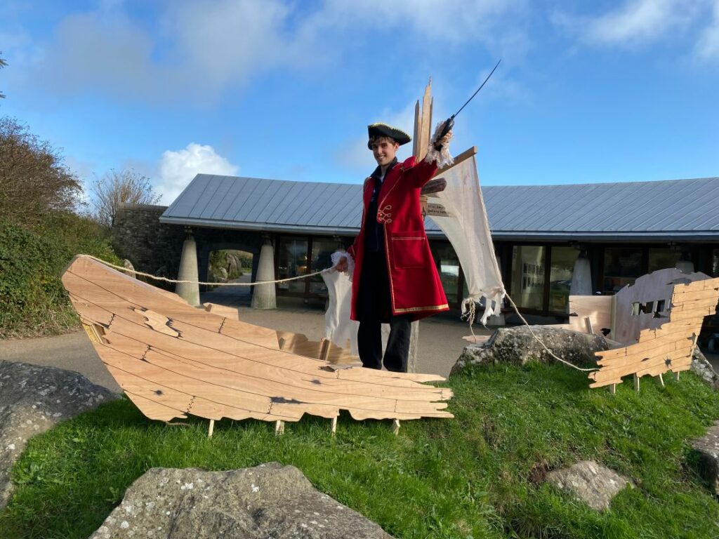 A man dressed as a pirate stands outside Oriel y Parc on a fine day