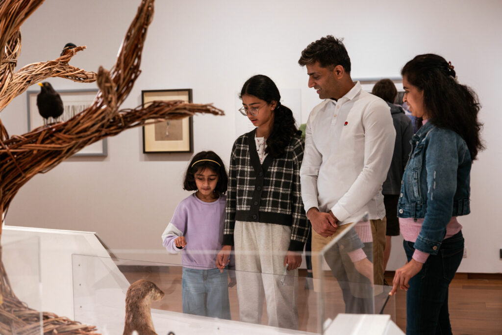 Family looking at exhibition display