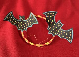 Image of a headband with spotty bats attached